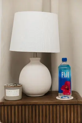 a table with a lamp and a blue bottle of fluid at Ocean Breeze Retreat in Los Angeles