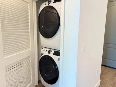two microwaves hanging on a wall next to a door at Luxury Stay Near Disneyland With Pool Gym & Free Parking in Santa Ana