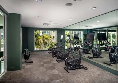 a gym with several treadmills and exercise bikes at Luxury Stay Near Disneyland With Pool Gym & Free Parking in Santa Ana