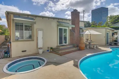 a home with a swimming pool in front of a house at Less Than 1 Mi to Universal Studios Home with Private Pool in Los Angeles
