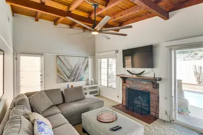 a living room with a couch and a fireplace at Less Than 1 Mi to Universal Studios Home with Private Pool in Los Angeles