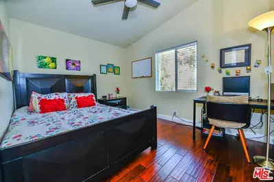 a bedroom with a bed and a desk with a computer at Beautiful, Spacious Agoura Malibu Zen House in Agoura Hills
