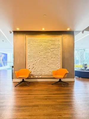 two orange chairs in a room with a large wall at Relax and recharge in this elegant 2BR loft - 108 - GL in Glendale