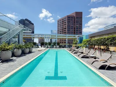a swimming pool with chaise lounges and chairs at Relax and recharge in this elegant 2BR loft - 108 - GL in Glendale