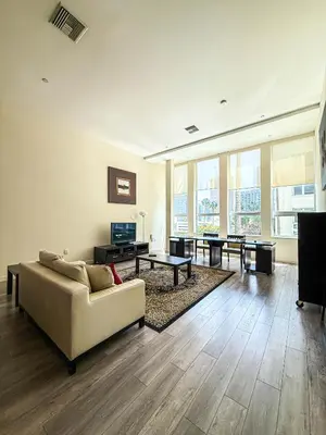 a living room with a couch and a tv at Relax and recharge in this elegant 2BR loft - 108 - GL in Glendale