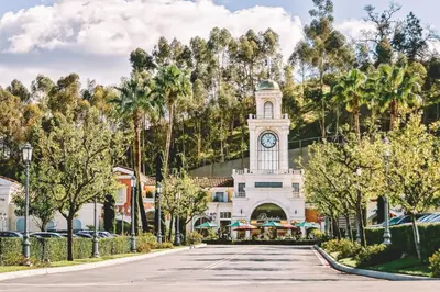 a building with a clock tower in the middle of a street at Cozy Designer Guesthouse with Style - RE in Calabasas