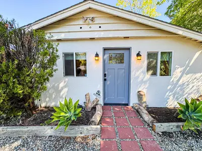 a small white house with a blue door at Cozy Designer Guesthouse with Style - RE in Calabasas