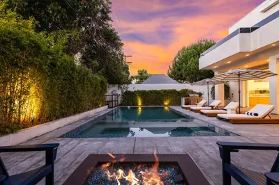 an outdoor living room with a pool and a fire pit at 5BR Modern West Hollywood Retreat in Los Angeles
