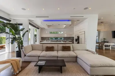 a living room with a white couch and a table at 5BR Modern West Hollywood Retreat in Los Angeles