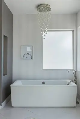 a white bathroom with a white tub and a window at 5BR Modern West Hollywood Retreat in Los Angeles