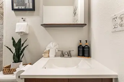 a bathroom sink with two bottles of wine on it at Echo Park Spacious Two-Bedroom Apartment with Private Yard and Parking in Los Angeles