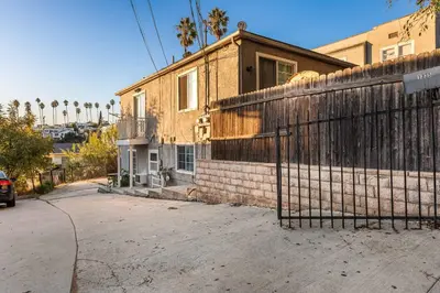 a building with a fence in front of it at Echo Park Spacious Two-Bedroom Apartment with Private Yard and Parking in Los Angeles