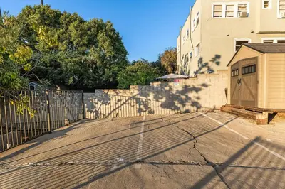 a driveway with a fence and a gate with a building at Echo Park Spacious Two-Bedroom Apartment with Private Yard and Parking in Los Angeles