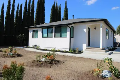 a white house with trees in the background at Newly Renovated La Habra 3bed 2 Bath in La Habra