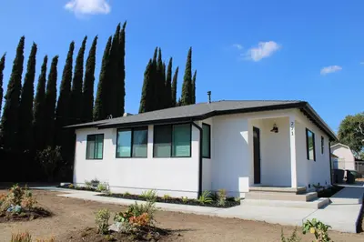 a white house with trees in the background at Newly Renovated La Habra 3bed 2 Bath in La Habra