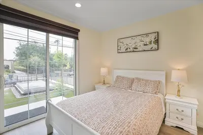 a bedroom with a bed and a large window at Stylish Pasadena Stay Near Old Town & Rose Bowl in Pasadena