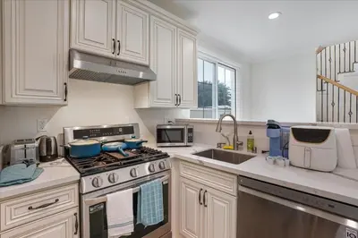 a kitchen with white cabinets and a stove top oven at Stylish Pasadena Stay Near Old Town & Rose Bowl in Pasadena