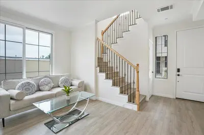 a living room with a couch and a staircase at Stylish Pasadena Stay Near Old Town & Rose Bowl in Pasadena