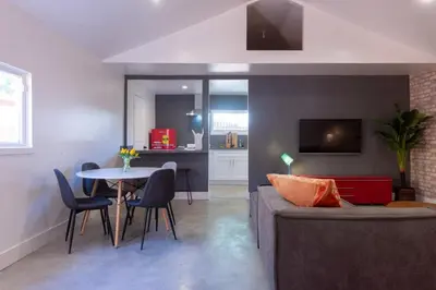 a living room with a couch and a table at Modern Private Guesthouse with Parking, Yard, and Washer Dryer in Inglewood