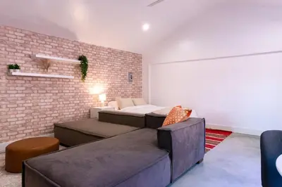 a bedroom with two beds and a brick wall at Modern Private Guesthouse with Parking, Yard, and Washer Dryer in Inglewood