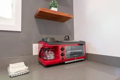 a red toaster oven sitting on top of a counter at Modern Private Guesthouse with Parking, Yard, and Washer Dryer in Inglewood