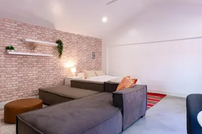 a bedroom with a bed and a brick wall at Modern Private Guesthouse with Parking, Yard, and Washer Dryer in Inglewood