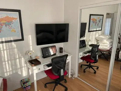 a room with a desk with two chairs and a television at 8670 San Carlos - South Gate CA - The Best 2 Rooms in South Gate