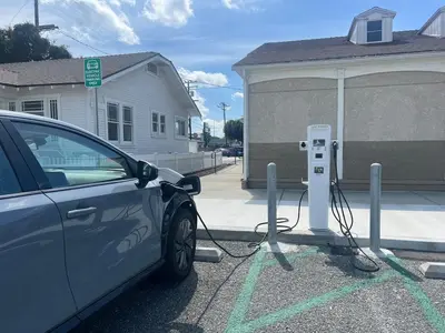 a car plugged into a parking meter in front of a house at 8670 San Carlos - South Gate CA - The Best 2 Rooms in South Gate