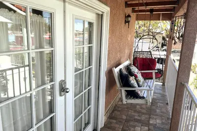an open door to a porch with a chair on a patio at 8670 San Carlos - South Gate CA - The Best 2 Rooms in South Gate