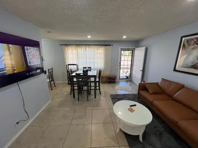 a living room with a couch and a table at 9621 San Juan - South Gate CA - Quick Drive to Hollywood & Beaches in South Gate
