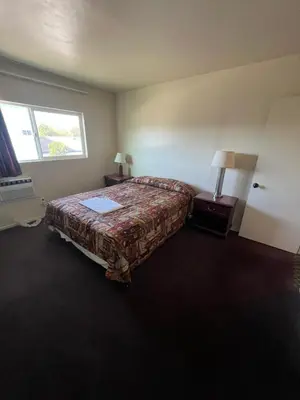 a hotel room with a bed and a window at York Motel in Los Angeles
