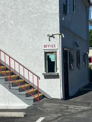 a white building with a sign that reads office at York Motel in Los Angeles