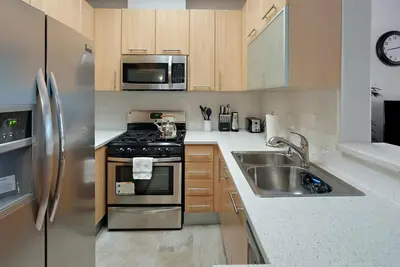 a kitchen with a stainless steel stove and a sink at Quiet 1- bedroom condo near LAX, SoFi, and the Beach in Los Angeles
