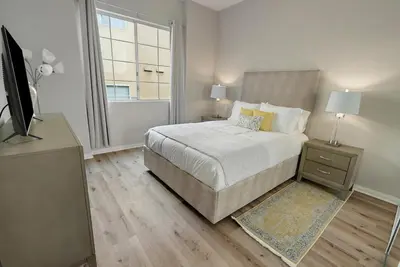 a white bedroom with a bed and a window at Quiet 1- bedroom condo near LAX, SoFi, and the Beach in Los Angeles