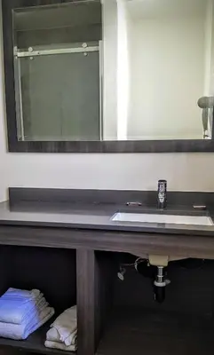 a bathroom with a sink and a mirror at Jewel City Inn in Glendale
