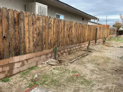 a wooden fence in front of a house at Desert Oasis Retreat in Barstow in Barstow