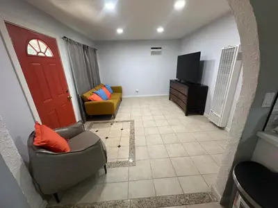 a living room with a couch and a tv at Desert Oasis Retreat in Barstow in Barstow