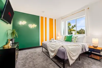 a bedroom with a bed and a large window at Spacious Luxury Villas in the heart of LA! Free parking and Jacuzzi in Los Angeles