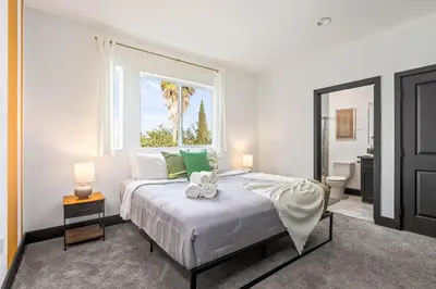 a bedroom with a large bed with a window at Spacious Luxury Villas in the heart of LA! Free parking and Jacuzzi in Los Angeles