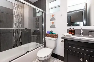 a bathroom with a toilet and a shower and a sink at Spacious Luxury Villas in the heart of LA! Free parking and Jacuzzi in Los Angeles