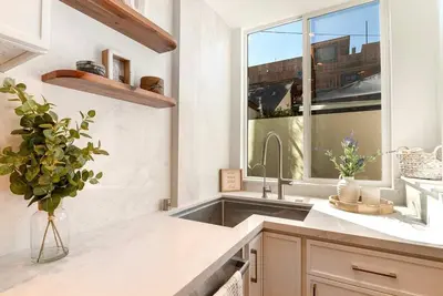 a kitchen with a sink and a large window at Modern 2BR Oasis with BBQ Sauna & Private Yard in Los Angeles