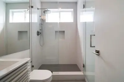 a bathroom with a shower with a toilet and a sink at Modern 2BR Oasis with BBQ Sauna & Private Yard in Los Angeles