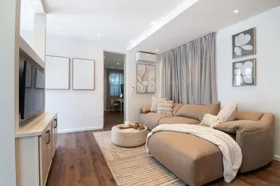 a living room with a couch and a tv at Modern 2BR Oasis with BBQ Sauna & Private Yard in Los Angeles