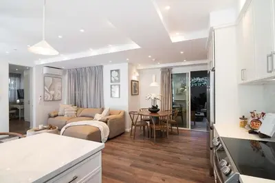 a kitchen and living room with a couch and a table at Modern 2BR Oasis with BBQ Sauna & Private Yard in Los Angeles