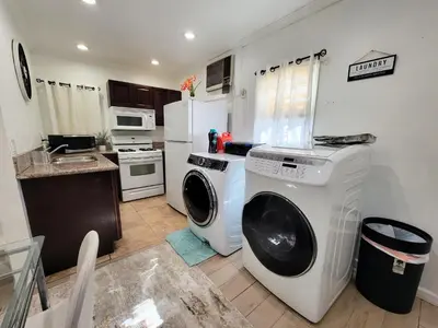 a kitchen with a washer and dryer in it at Two bedroom private guesthouse in great location Close to Melrose Hollywood sign and attractions in Los Angeles