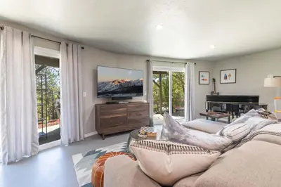 a living room with a couch and a flat screen tv at The Great Escape Beach Access, Near Slopes, View in Lake Arrowhead