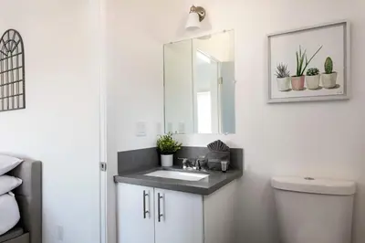 a bathroom with a sink and a mirror at Experience Luxury 4BR Townhouse Sleeps 8 with Parking in Los Angeles