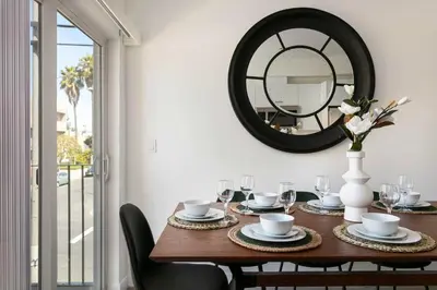 a dining room with a table with a mirror at Experience Luxury 4BR Townhouse Sleeps 8 with Parking in Los Angeles
