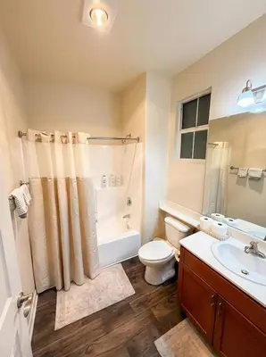 a bathroom with a toilet and a shower and a sink at 1BR Luxury Apartment - Luxury Resort Amenities in Los Angeles