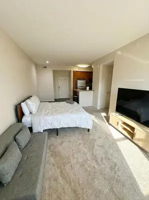 a large bedroom with a bed and a couch at 1BR Luxury Apartment - Luxury Resort Amenities in Los Angeles